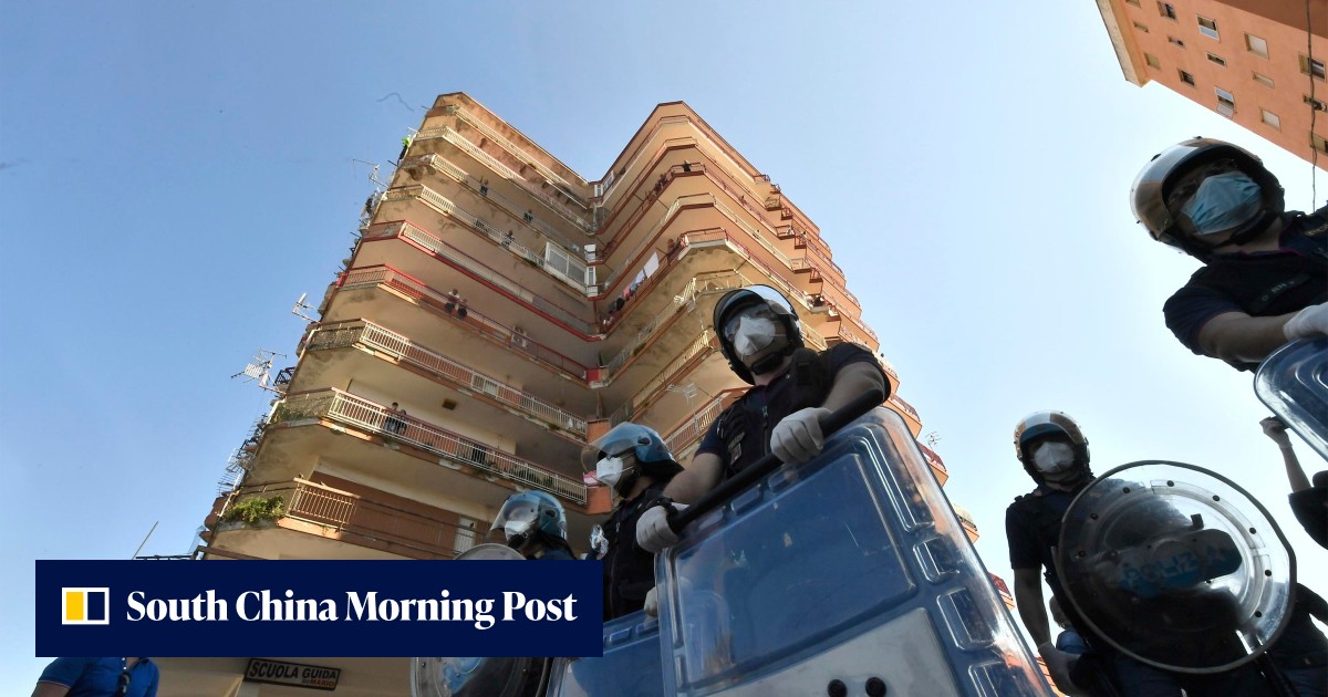 Riot police deployed as tensions erupt at coronavirus-hit housing ...