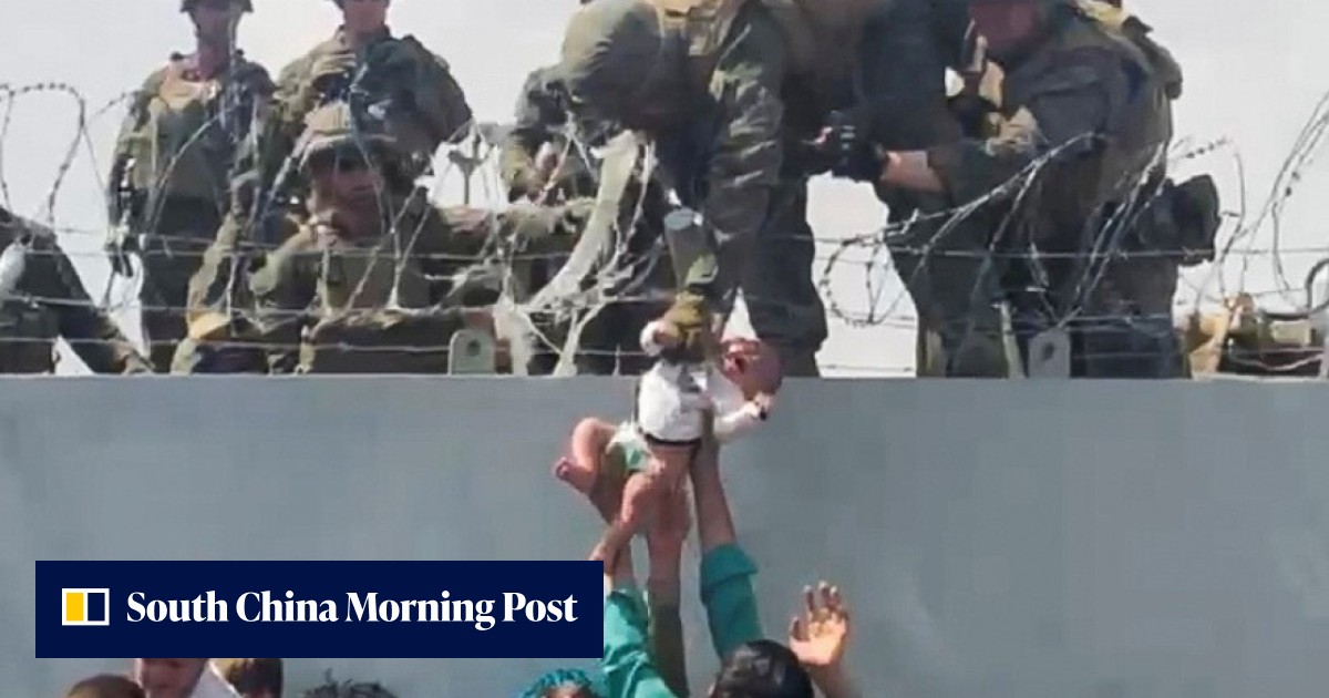 Afghanistan: Viral video of soldier lifting baby over razor wire ...