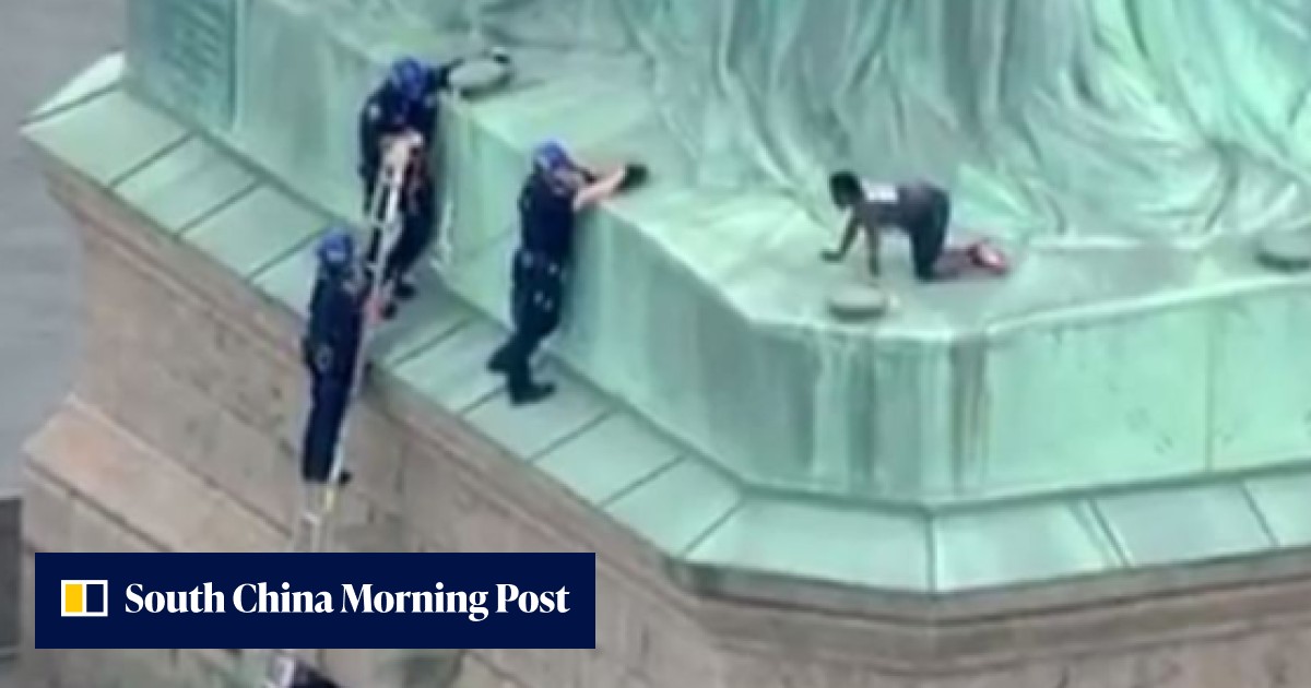 Statue of Liberty is evacuated as immigration protester climbs base ...