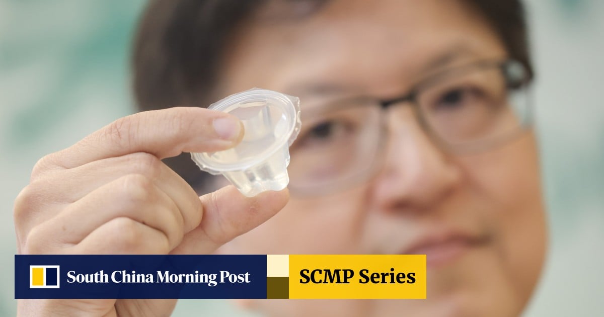 A person holding a transparent, gel-like piece of konjac jelly, with a blurred background and a warning about choking hazards from the Centre for Food Safety, Hong Kong, 2025.