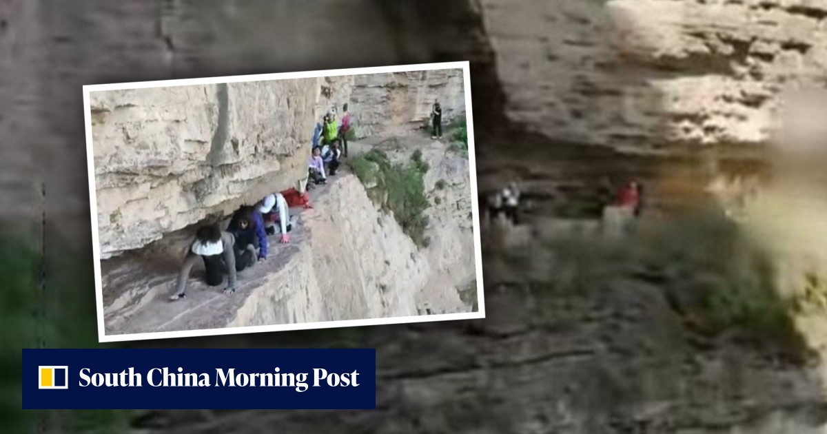 Chinese tourists filmed crawling on cliff edge without safety gear prompts official probe as mainland social media questions tourism value of dangerous thrill-seeking - Vimarsana News