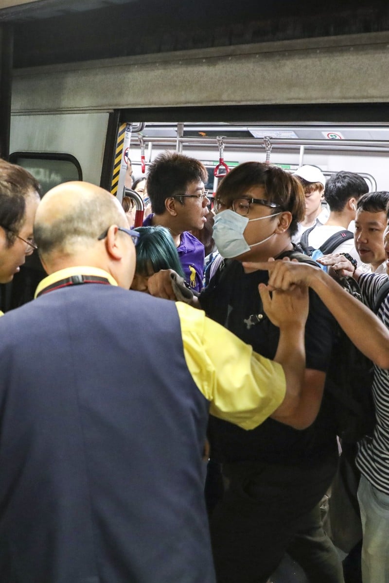 HK protests: Rush hour chaos as protesters block train doors - Young ...