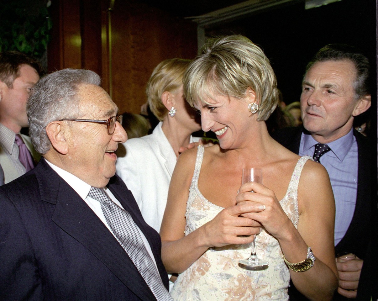 Diana, Princess Of Wales speaks to Henry Kissinger at a gala party to launch the sale of her dresses in 1997. Photo: Getty Images