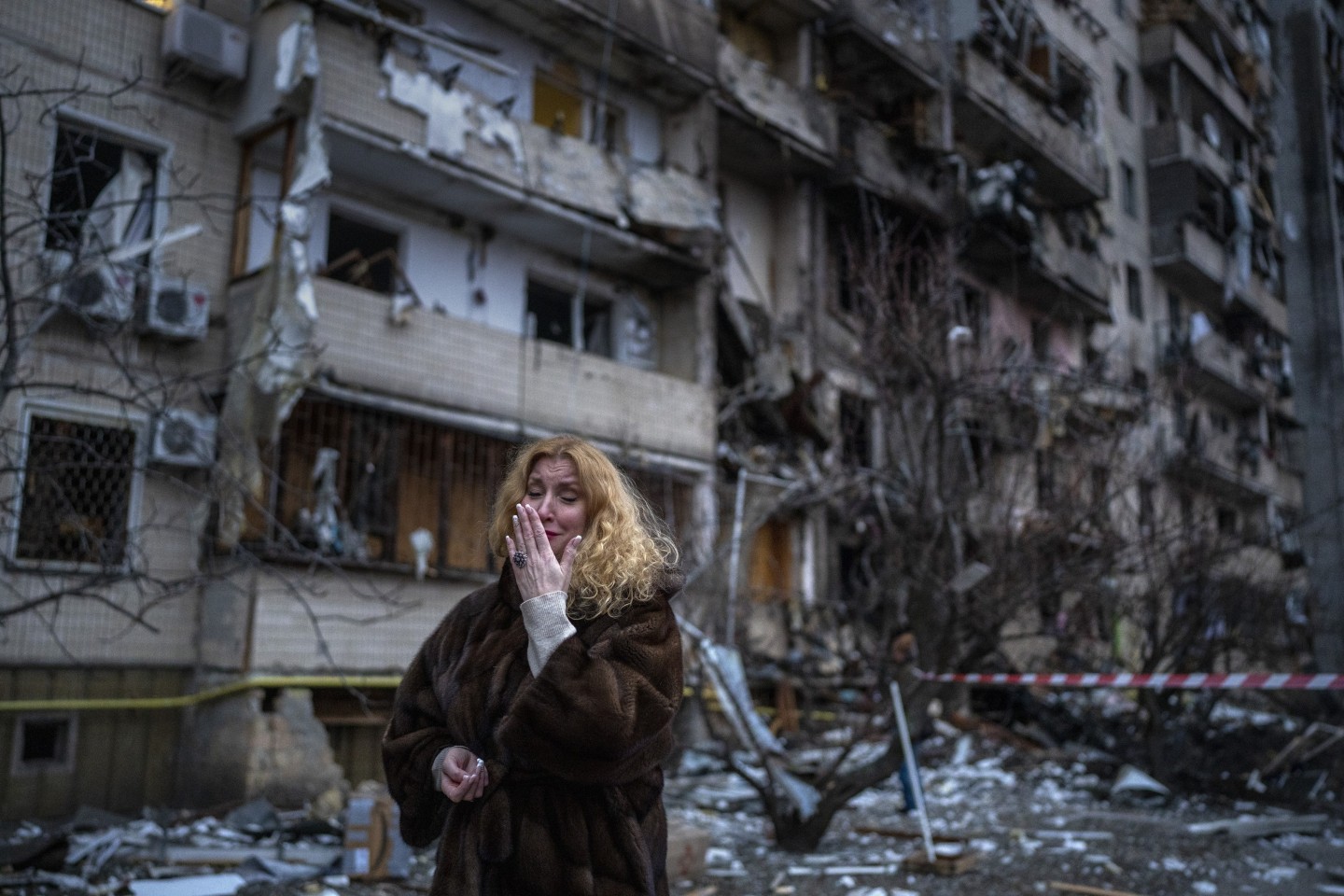 Natali Sevriukova walks past her apartment block following a rocket attack on the city of Kyiv, Ukraine, on February 25, 2022. Photo: AP