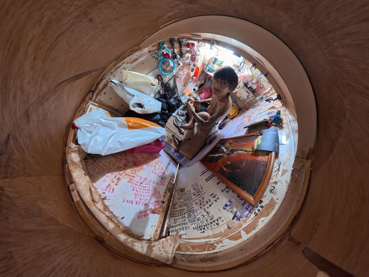 Wong, 55, in his “coffin home” in Sham Shui Po. Photo: Eugene Lee