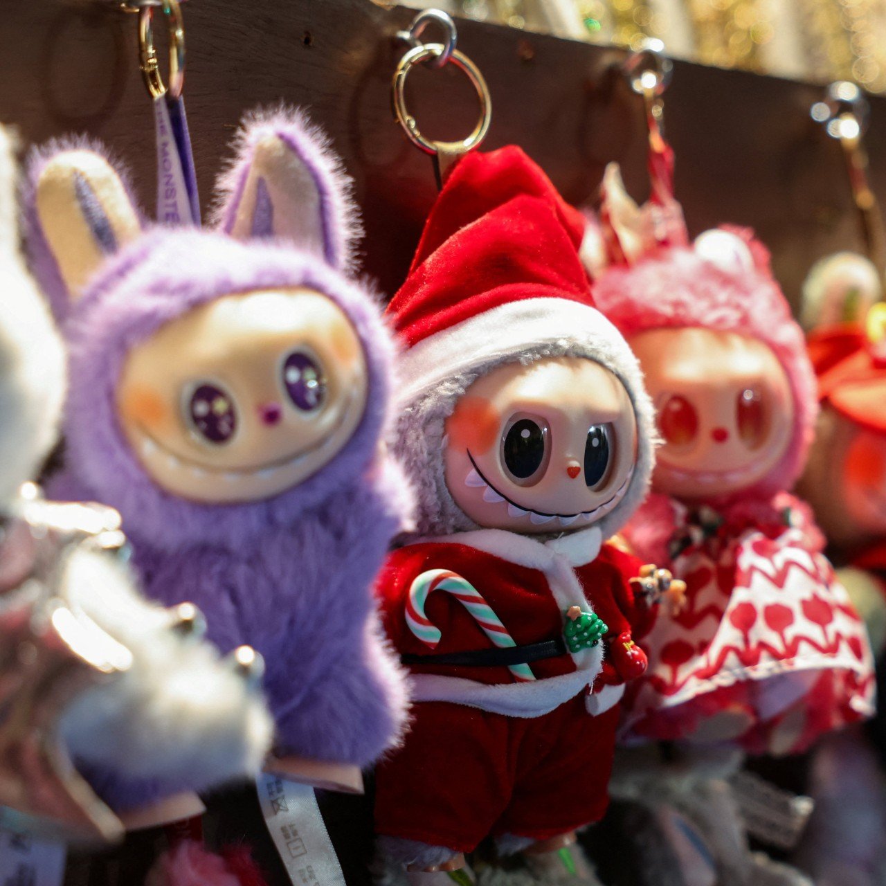 Labubus hang for sale at a market in New York’s Times Square in November 2025. The dolls’ unprecedented popularity has led their value to surge as many buy them as investments and keep them entombed in plastic cases. Photo: Reuters