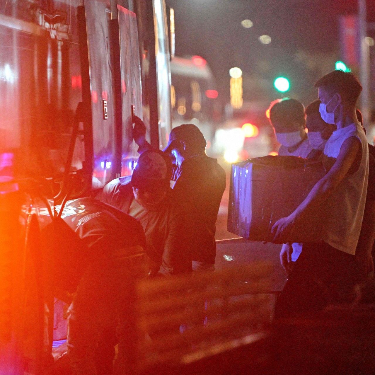 People carry their belongings onto a bus as they leave a suspected scam centre compound in Sihanoukville, Cambodia, last month. Photo: AFP