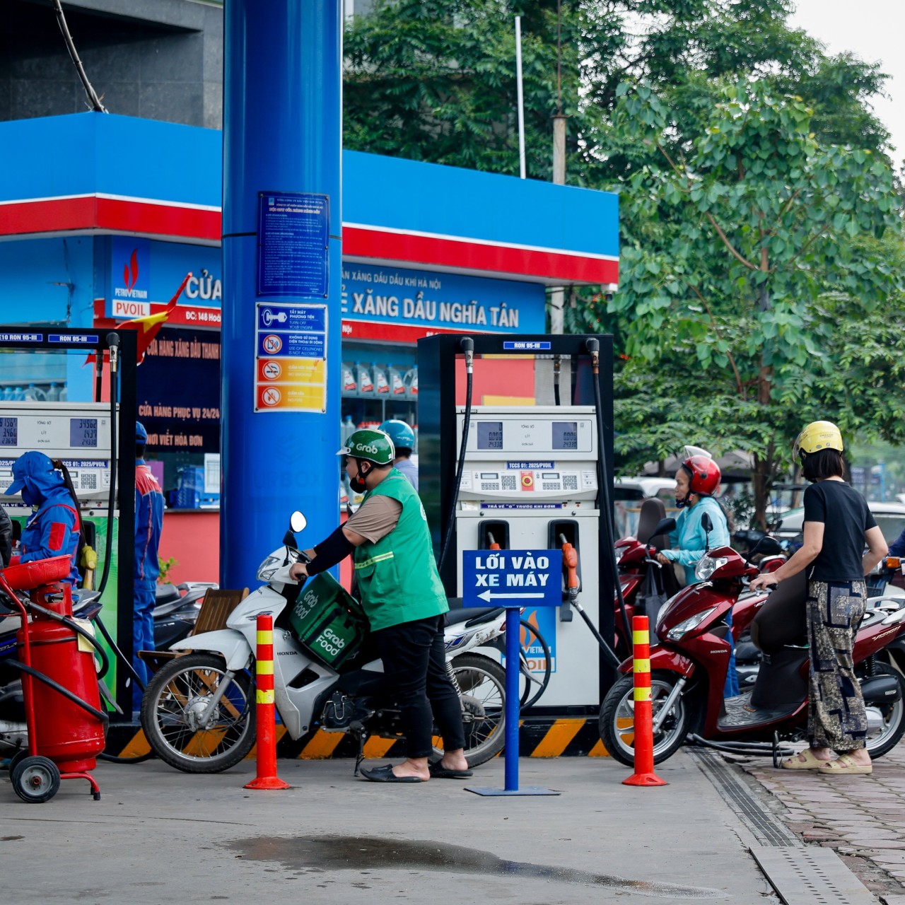 People wait to refill their motorbikes at a petrol station in Hanoi, Vietnam, on Monday. Photo: EPA