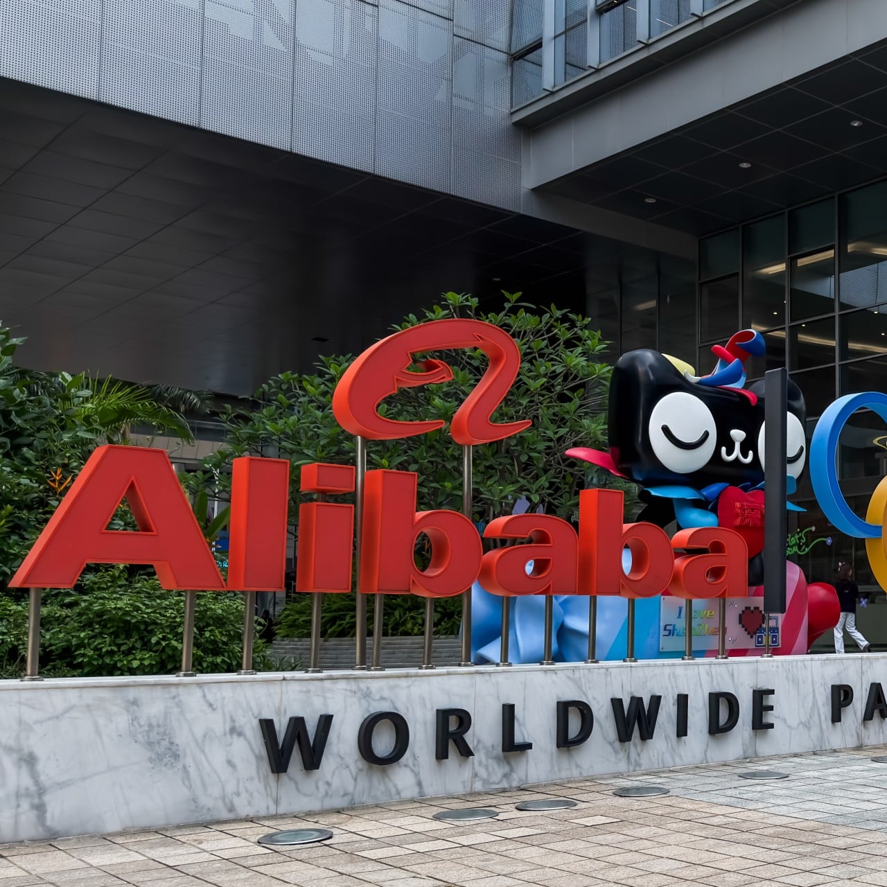 A man walks past an Alibaba display featuring the Olympic rings outside an Alibaba office building in Shenzhen, Guangdong province, on Tuesday. Photo: Getty Images