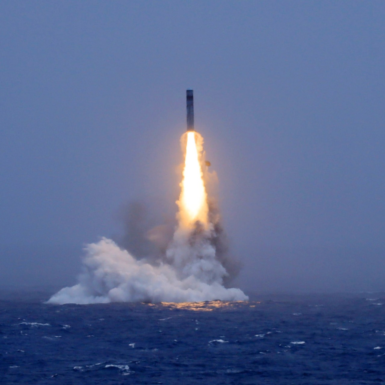 A long-range ballistic missile bursts out of the sea during a test launched from a Chinese nuclear-powered submarine in the South Pacific on Monday. Photo: Xinhua/AP