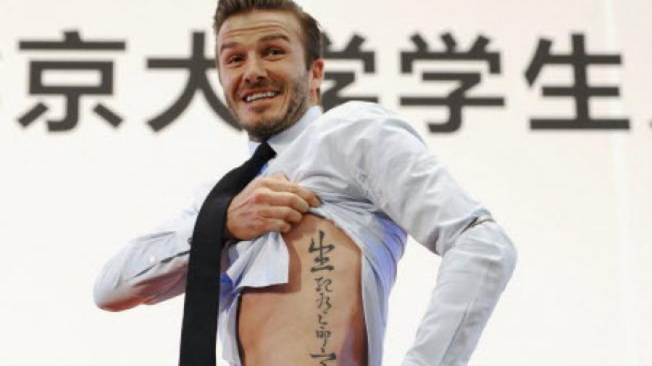 Footballers Tattoos - David Beckham's left arm has a lot of designs that  seem to focus on his wife and his personal life. Inside of his left arm he  got “Victoria” written