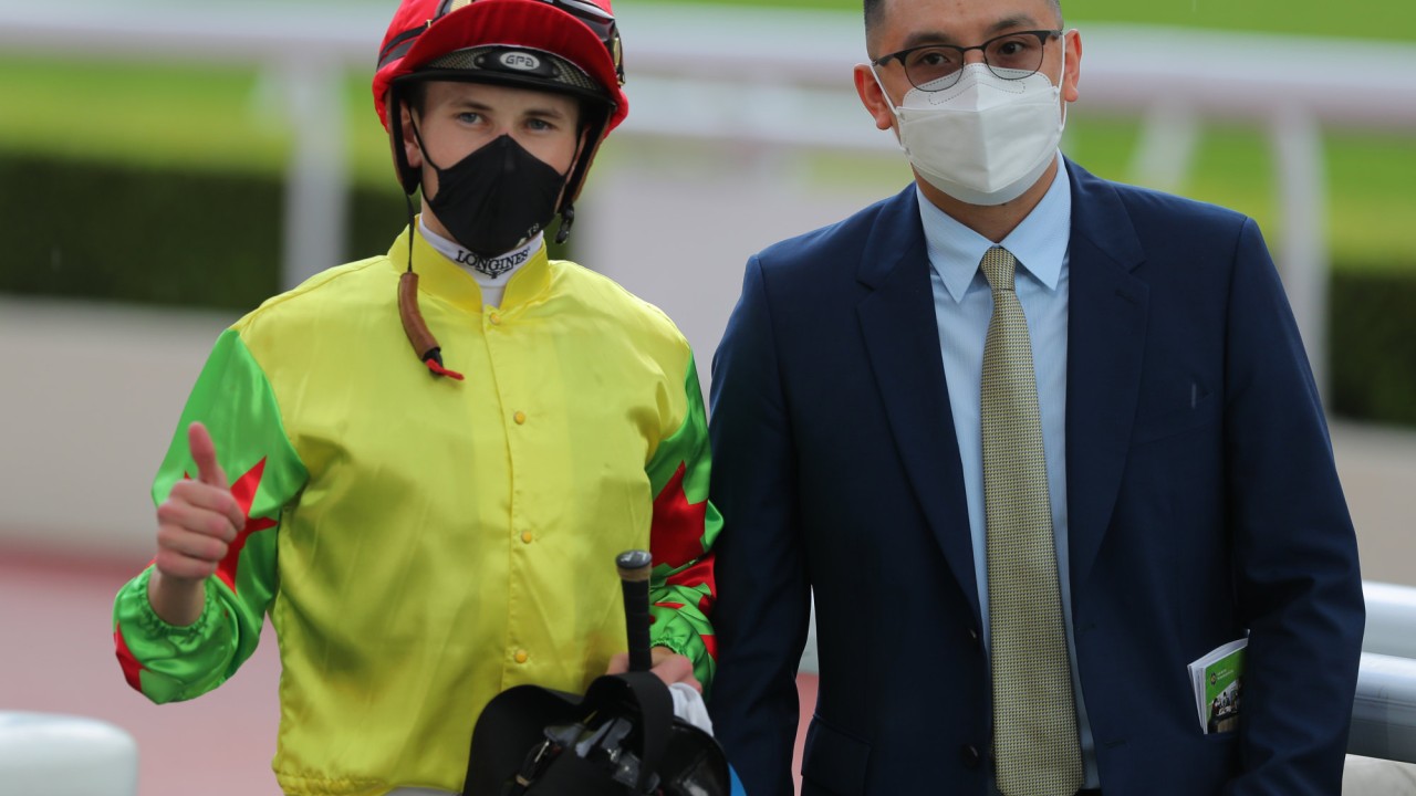 Jockey Luke Ferraris and trainer Pierre Ng after Happy Sharing’s win.