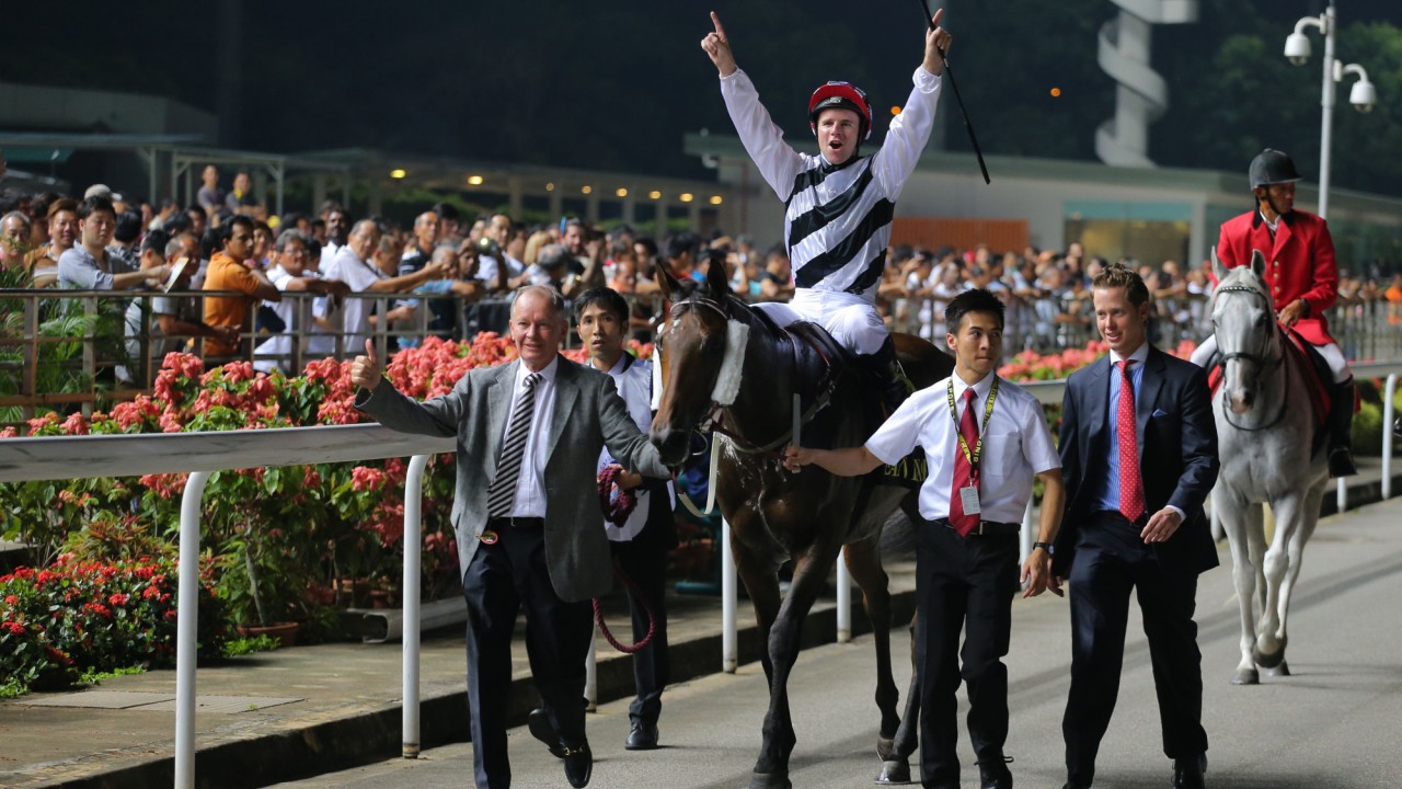 Trainer John Moore (left) and jockey Tomy Berry celebrate Dan Excel’s 2015 Singapore Airlines International Cup victory at Kranji.