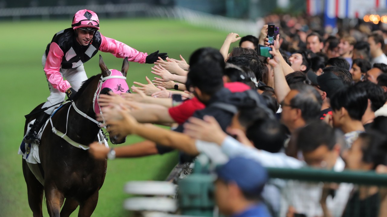 Brenton Avdulla high-fives the Happy Valley crowd after booting home Atomic Beauty.