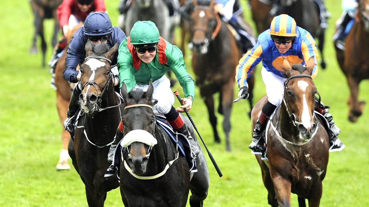 Harzand (centre) wins the 2016 Epsom Derby for the Aga Khan. Photo: EPA