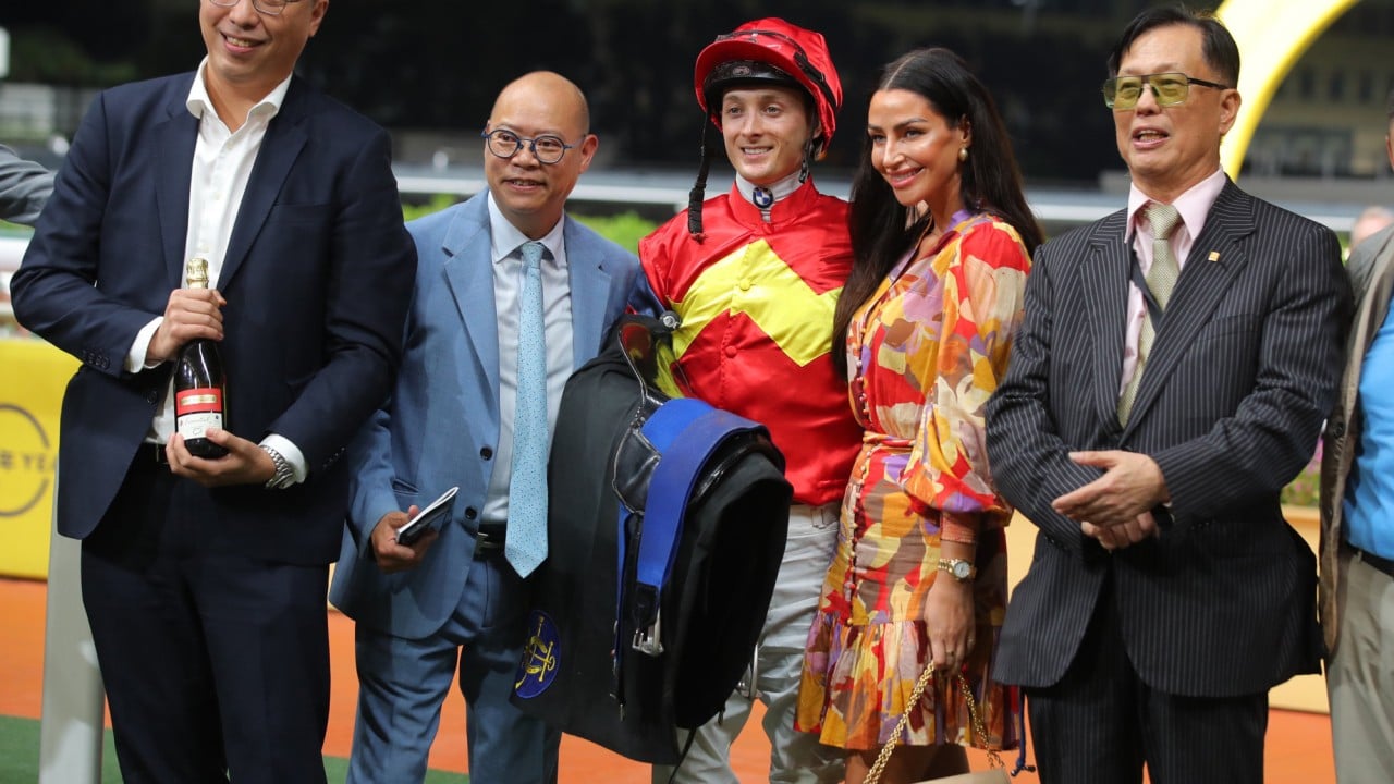Trainer Chris So (second from left), jockey Harry Bentley (centre) and connections of Hong Lok Golf celebrate.