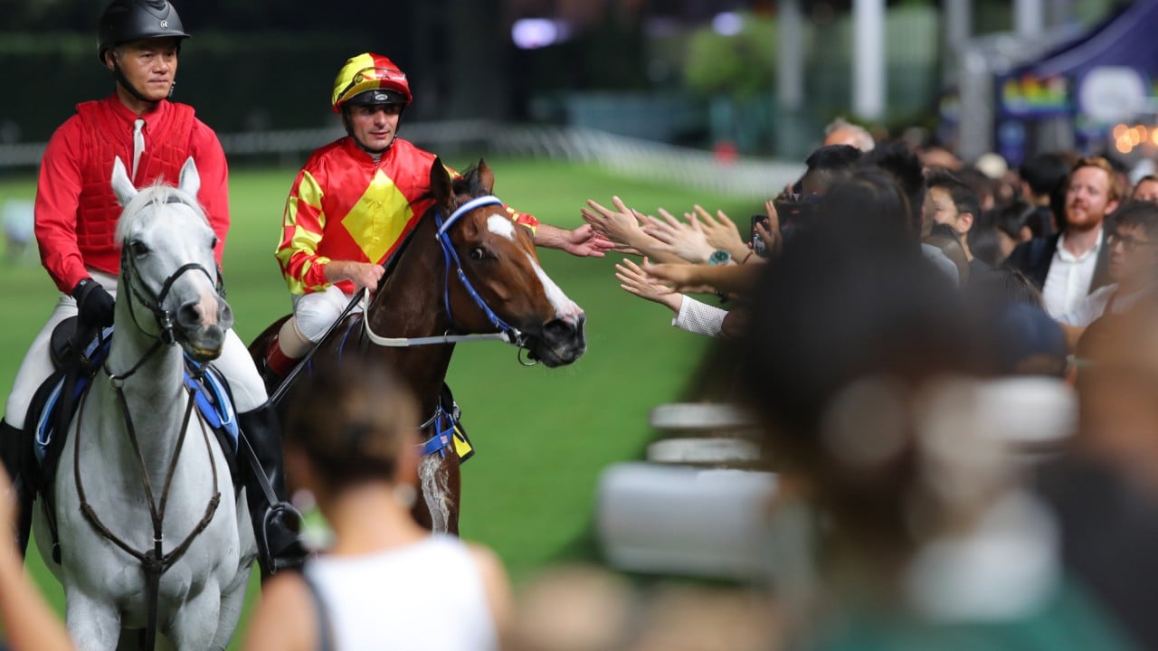 Andrea Atzeni high-fives the Valley crowd after booting home Autumn Delight.