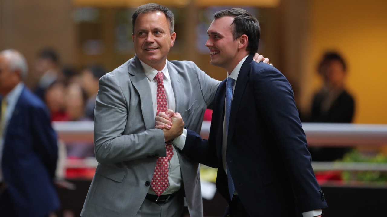 Caspar Fownes celebrates a Happy Valley win with son Ronan. Photos: Kenneth Chan