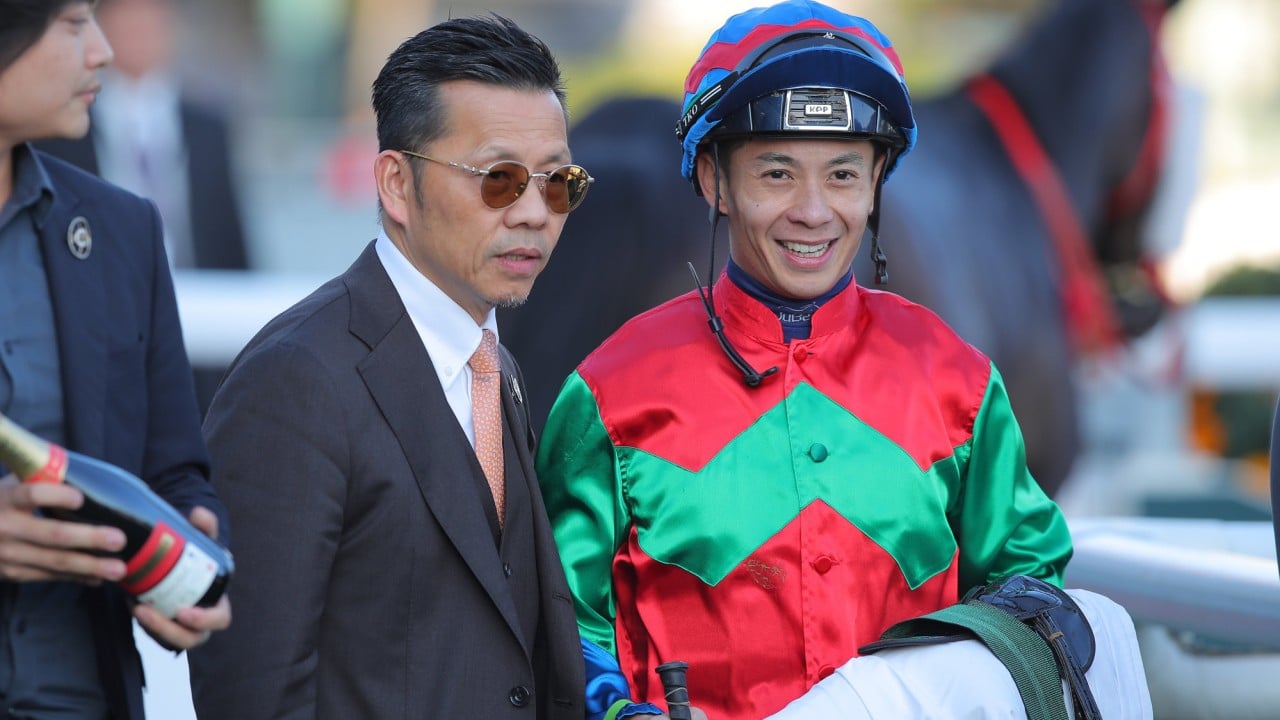 Trainer Frankie Lor and jockey Derek Leung after Money Catcher’s victory.