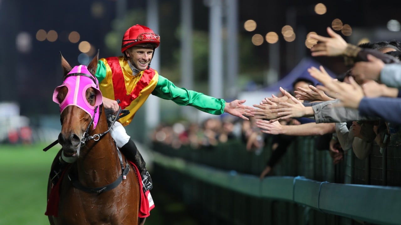 Lyle Hewitson high-fives the Valley crowd after guiding Speed Dragon to victory.