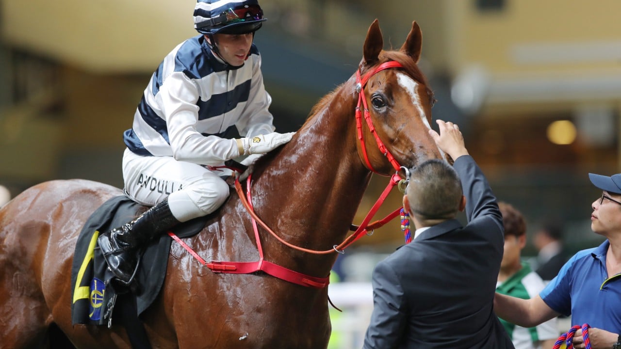 Danny Shum pats Harmony Galaxy after his victory at Happy Valley.