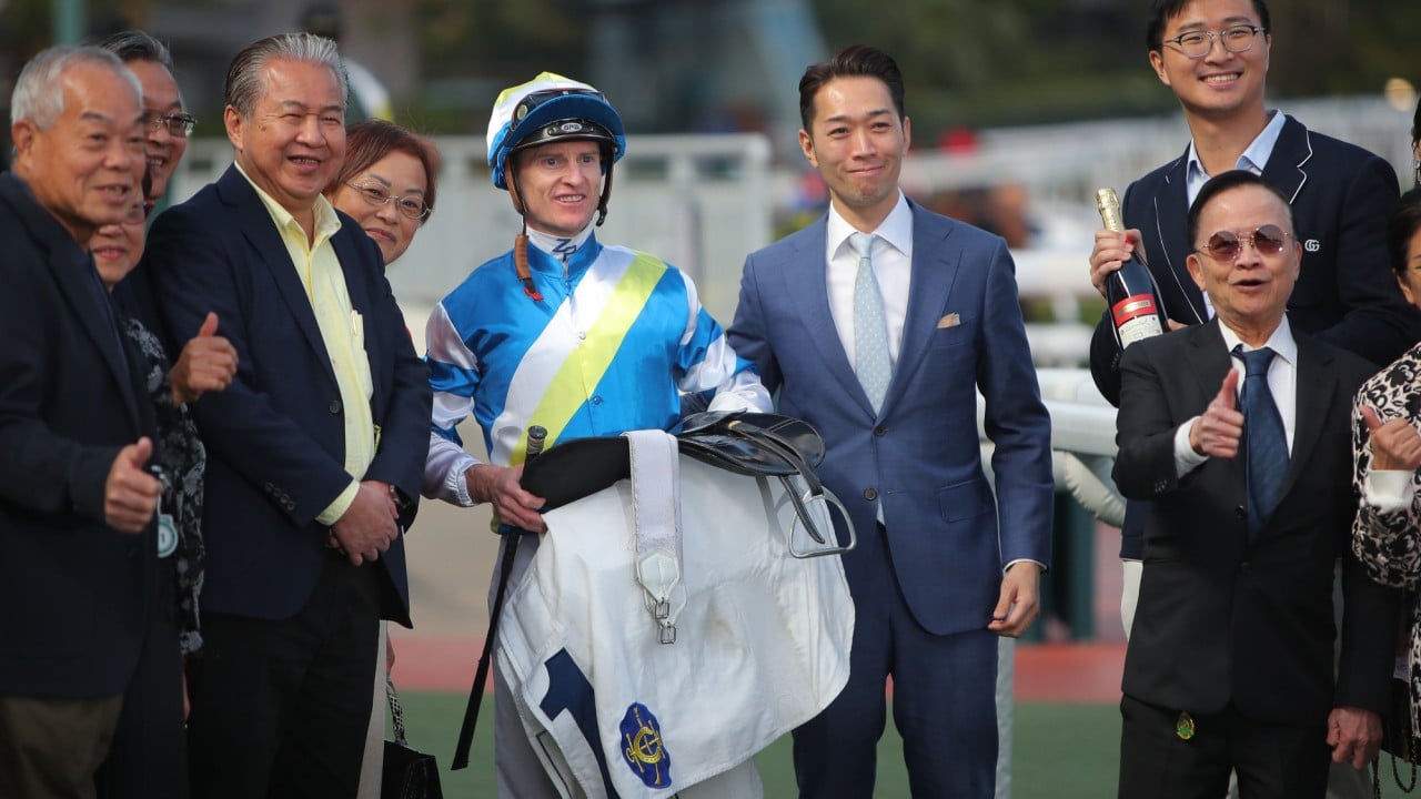 Jockey Zac Purton with connections of Patch Of Cosmo after his win in January.