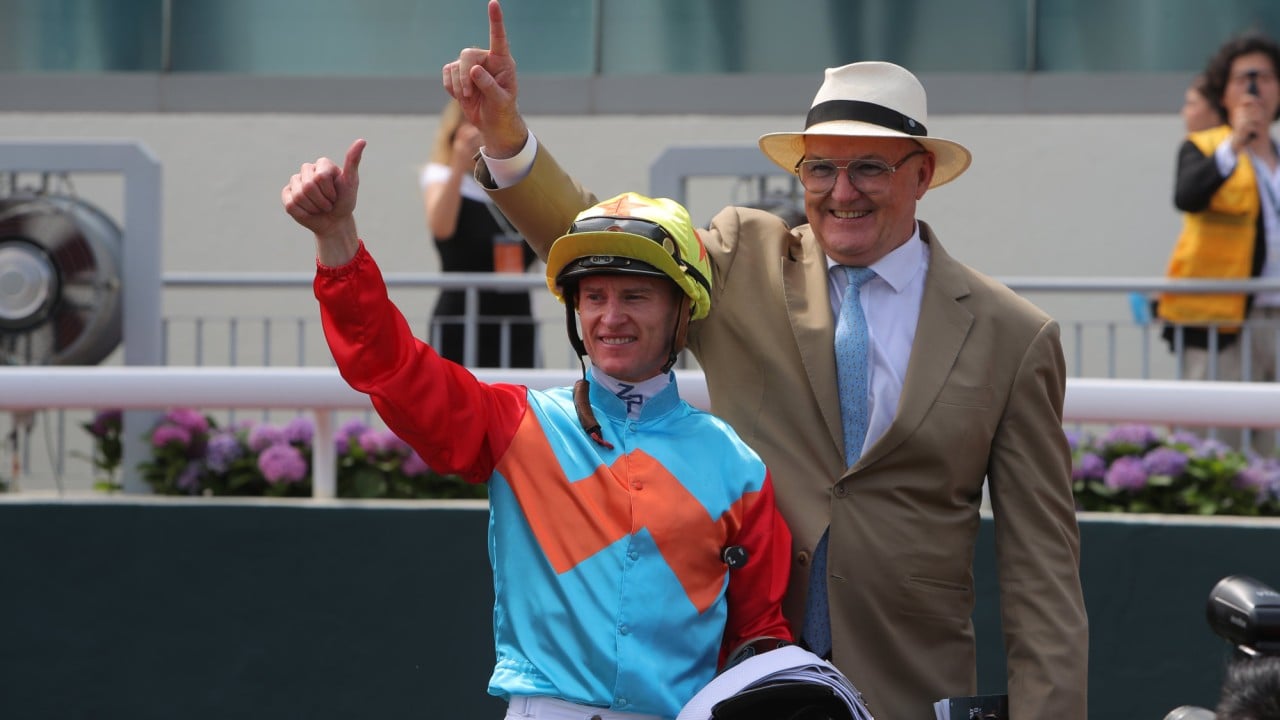 Jockey Zac Purton and trainer David Hayes celebrate Ka Ying Rising’s Chairman’s Sprint Prize win.