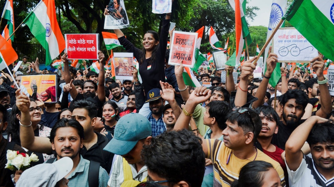 Protesters celebrate after India’s education minister quits
