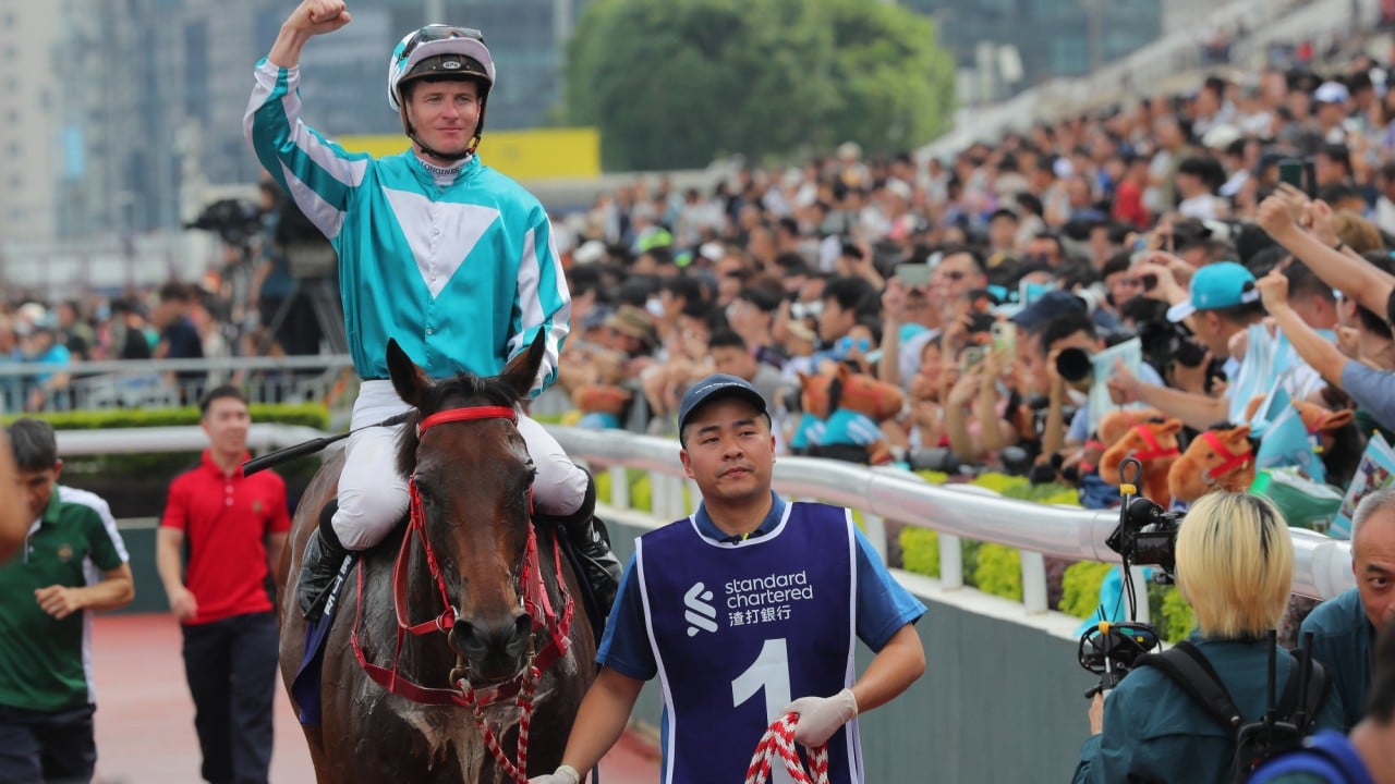 James McDonald pumps his fist in celebration after Romantic Warrior seals Triple Crown glory.
