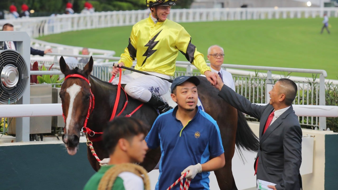 Jockey Zac Purton and trainer Danny Shum celebrate Nyx Gluck’s victory.