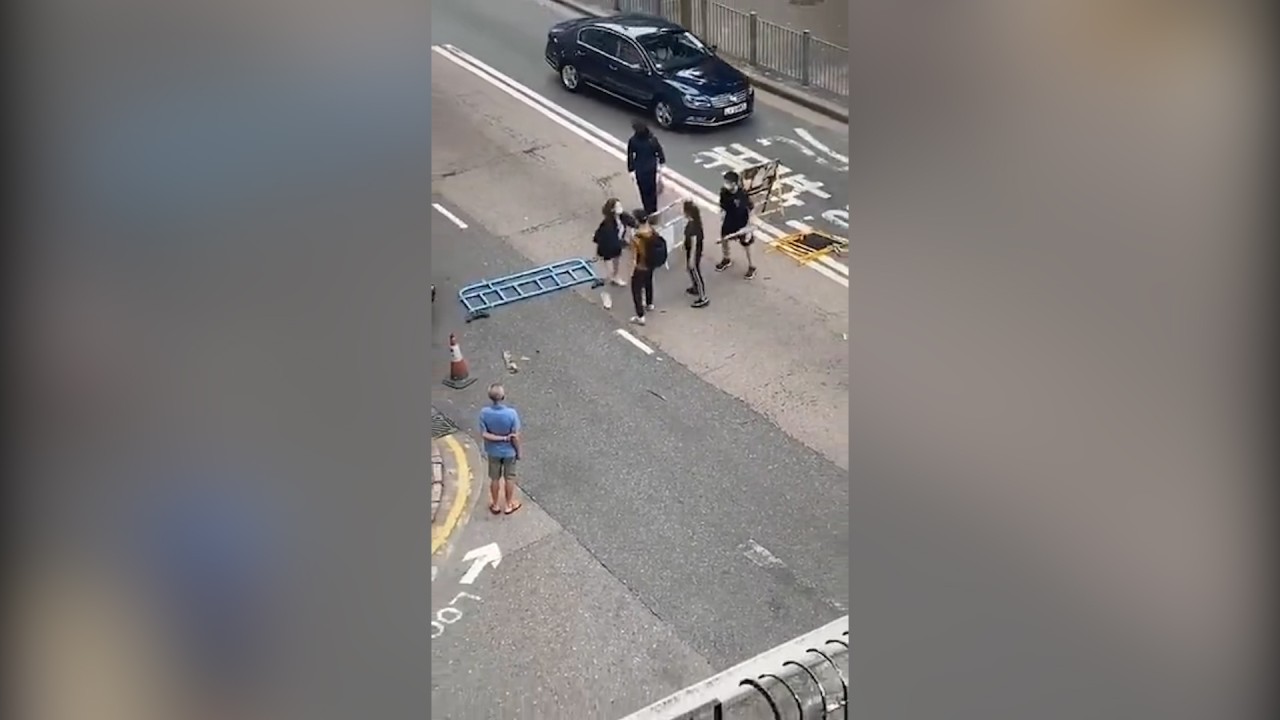 Online video footage shows woman trying to remove roadblocks being attacked 