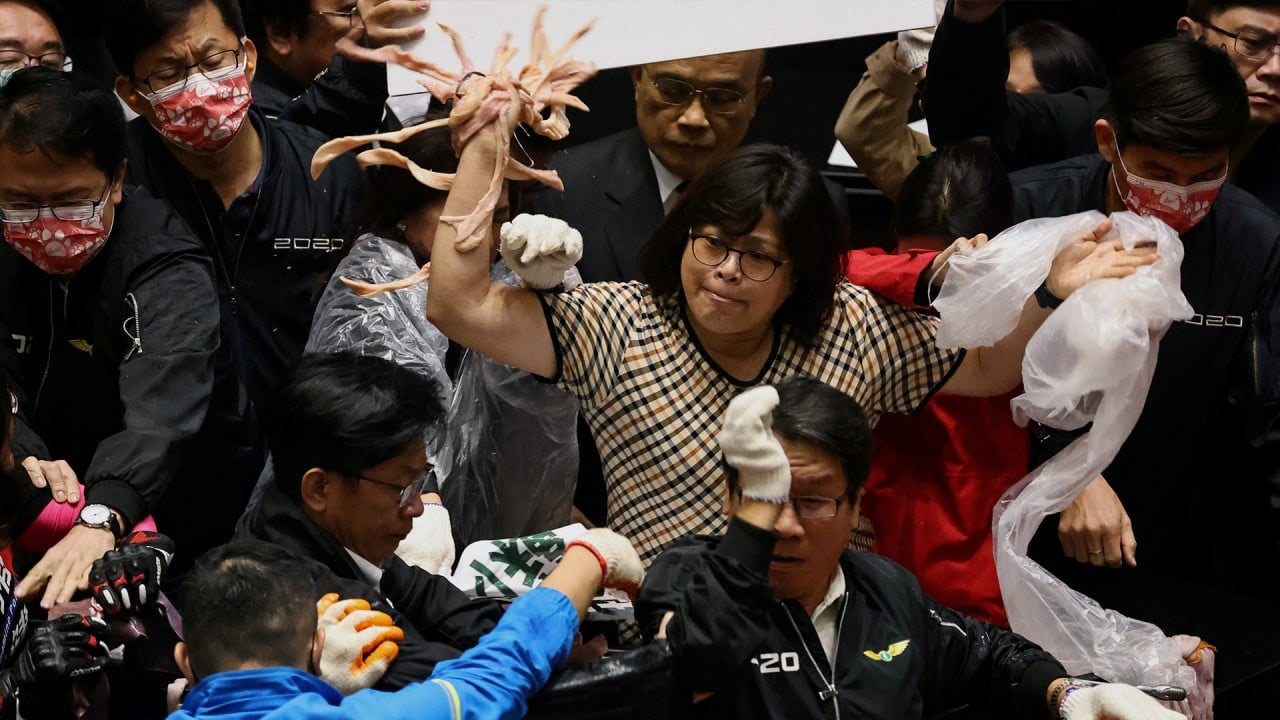 Pig guts fly in Taiwan parliament protest over easing of restrictions on US pork imports