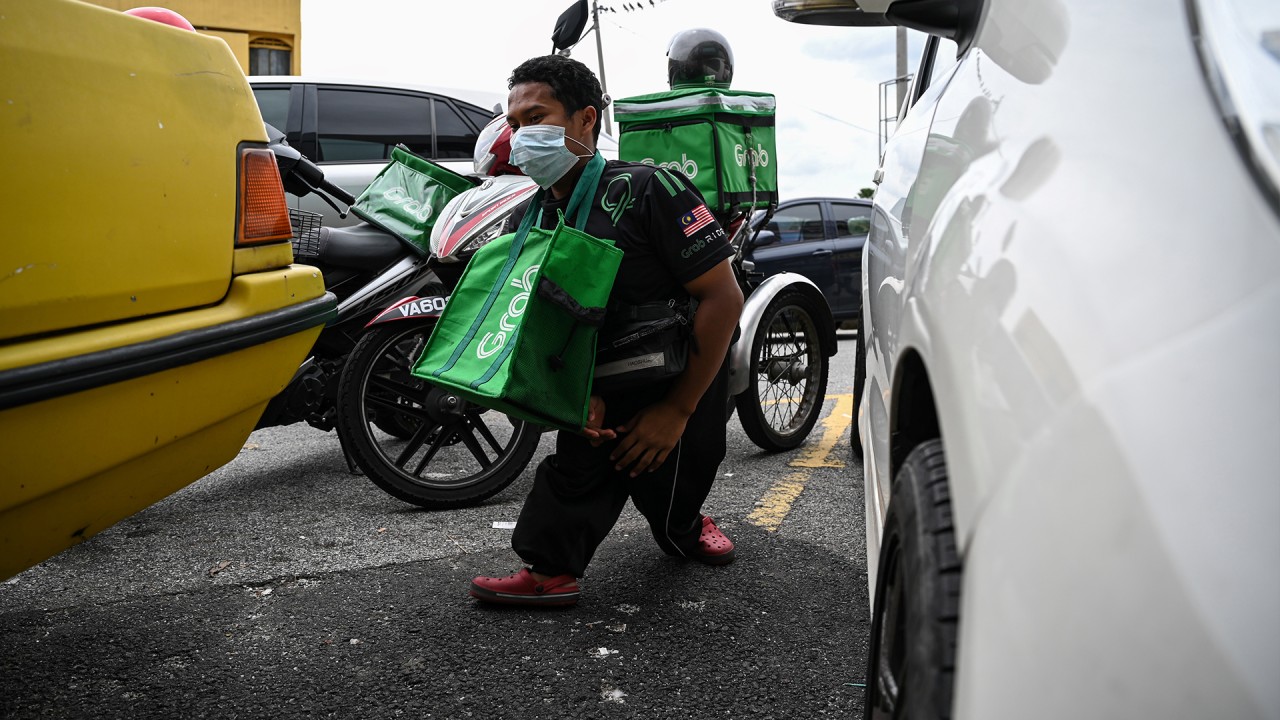 Disabled food delivery rider on front line of Malaysia’s fight against Covid-19 pandemic 