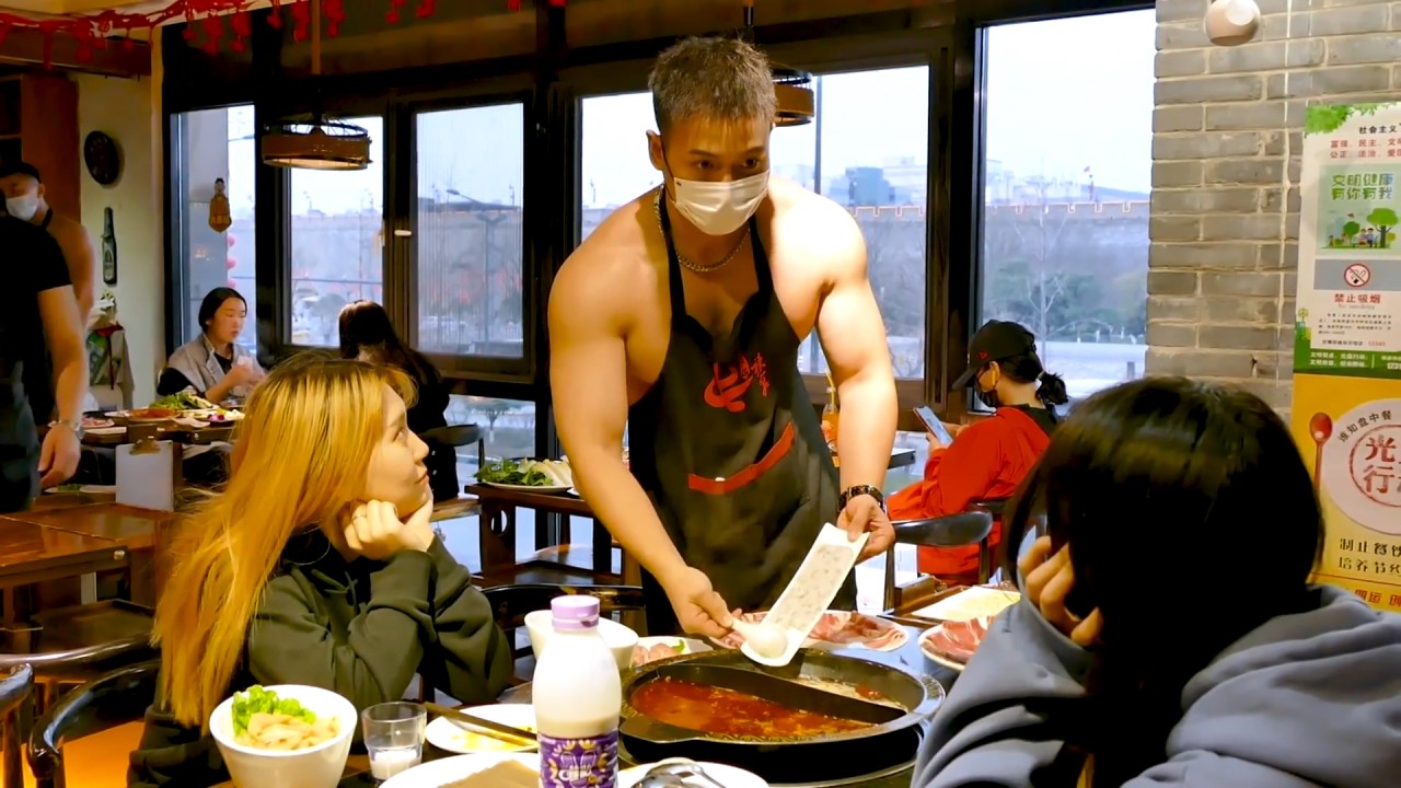 Male topless models serving in Chinese hotpot restaurant turn shop into viral hit