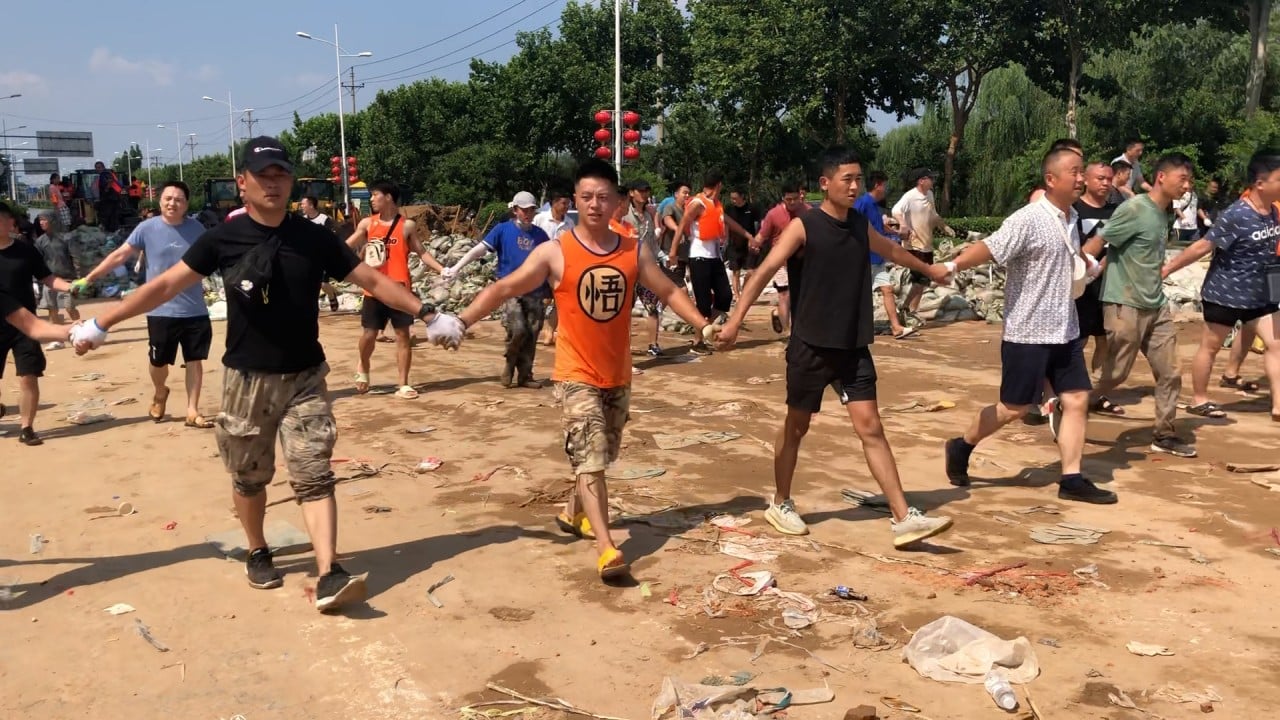 Thousands of residents in central China's Xinxiang city band together to fight rising floodwaters