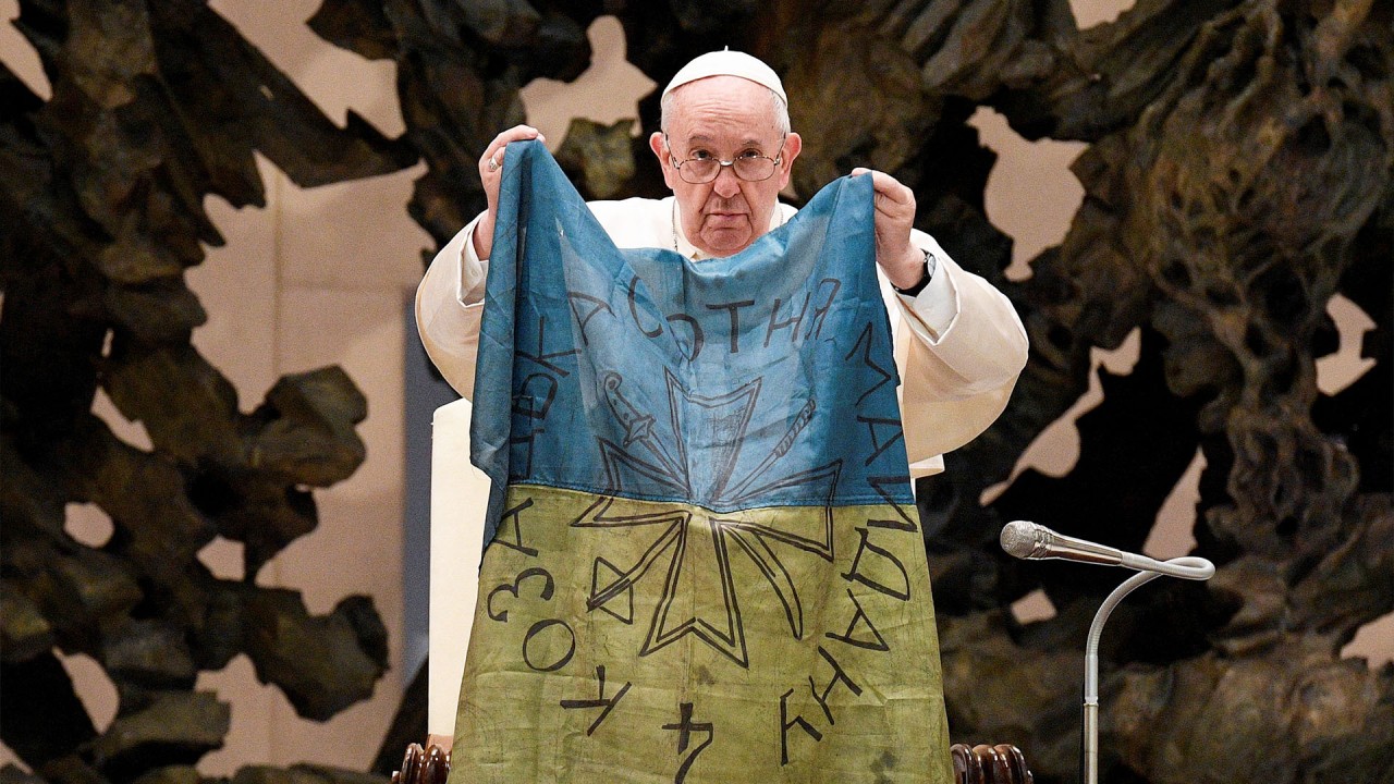 Pope Francis kisses Ukrainian flag from Bucha, where hundreds of civilians were reportedly killed