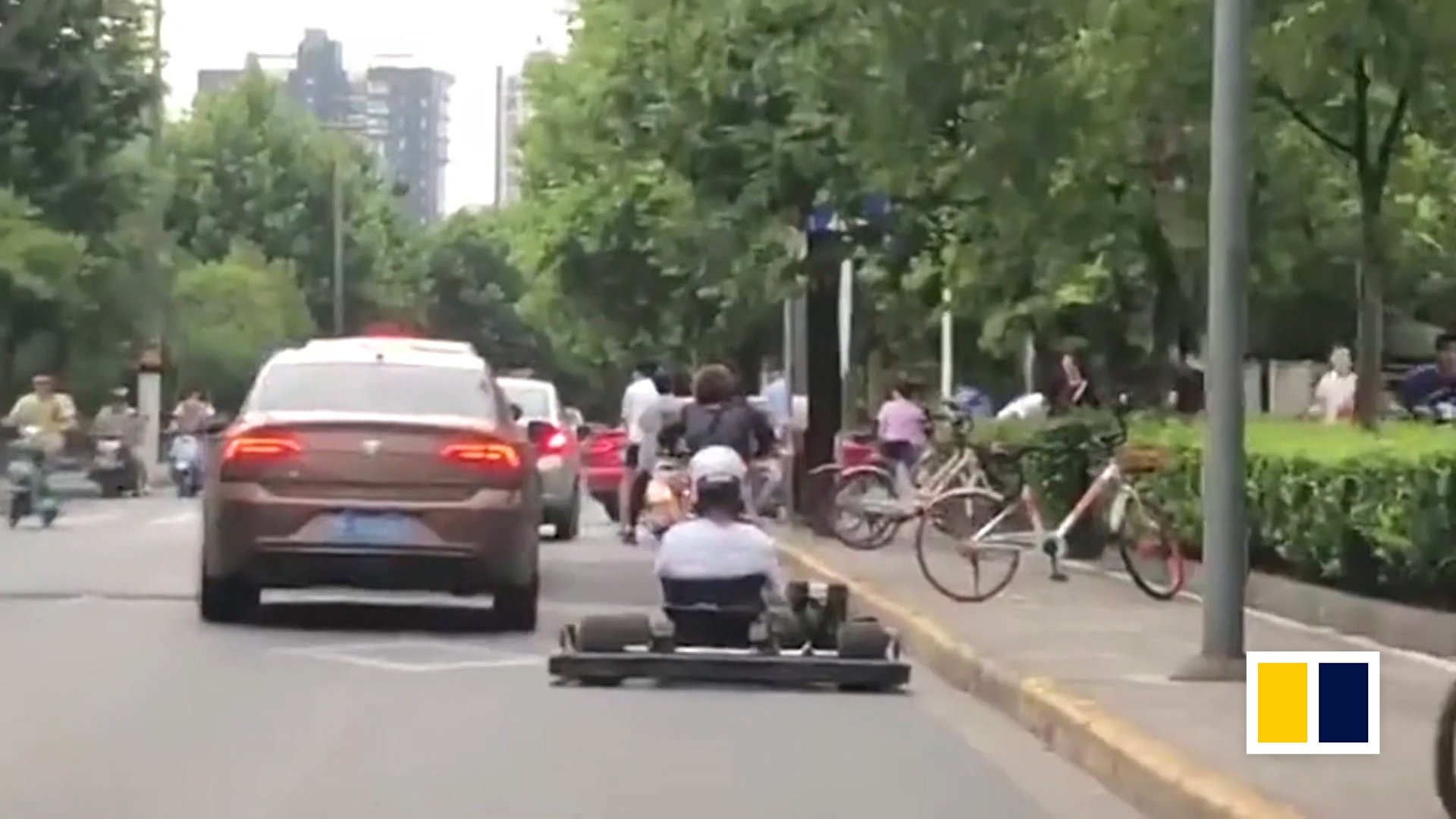 Chinese man drives go-kart on busy road