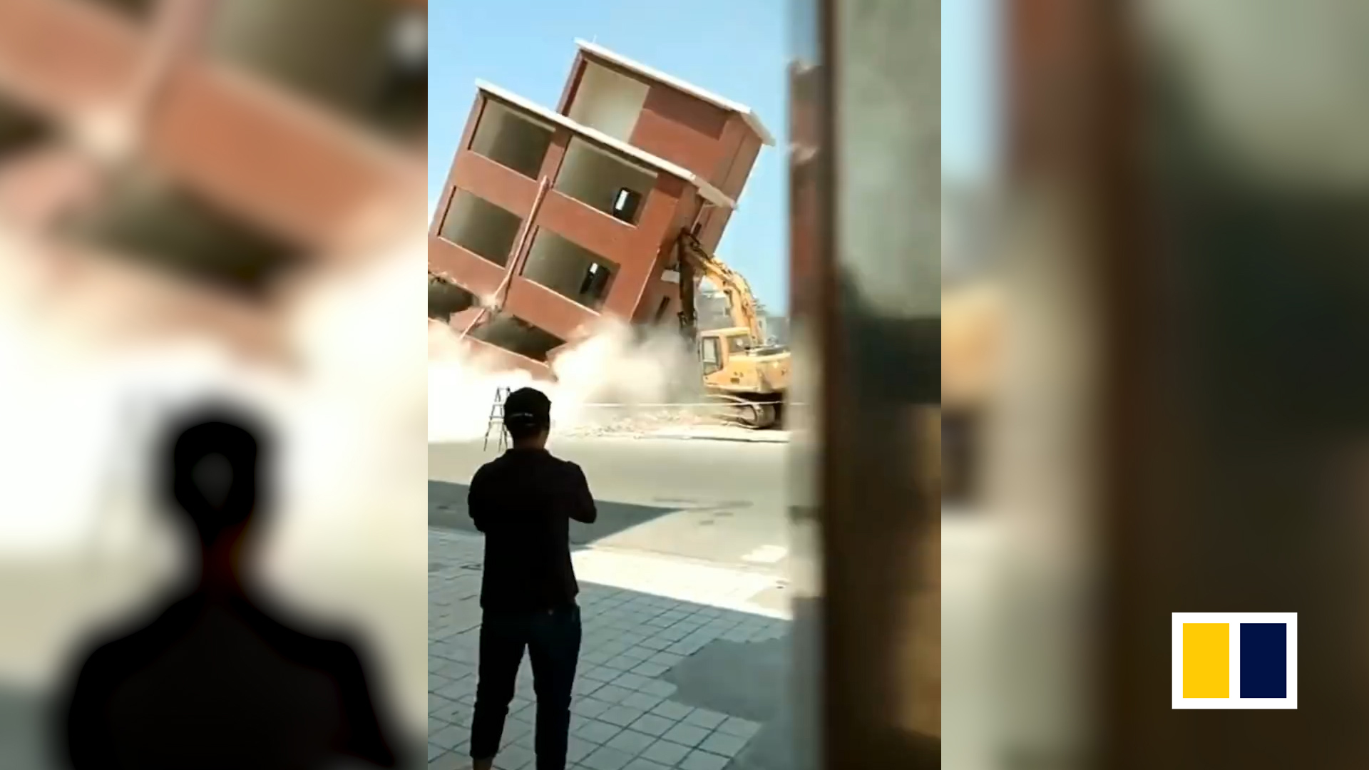 Excavator gets buried by collapsing building after operator misjudged direction