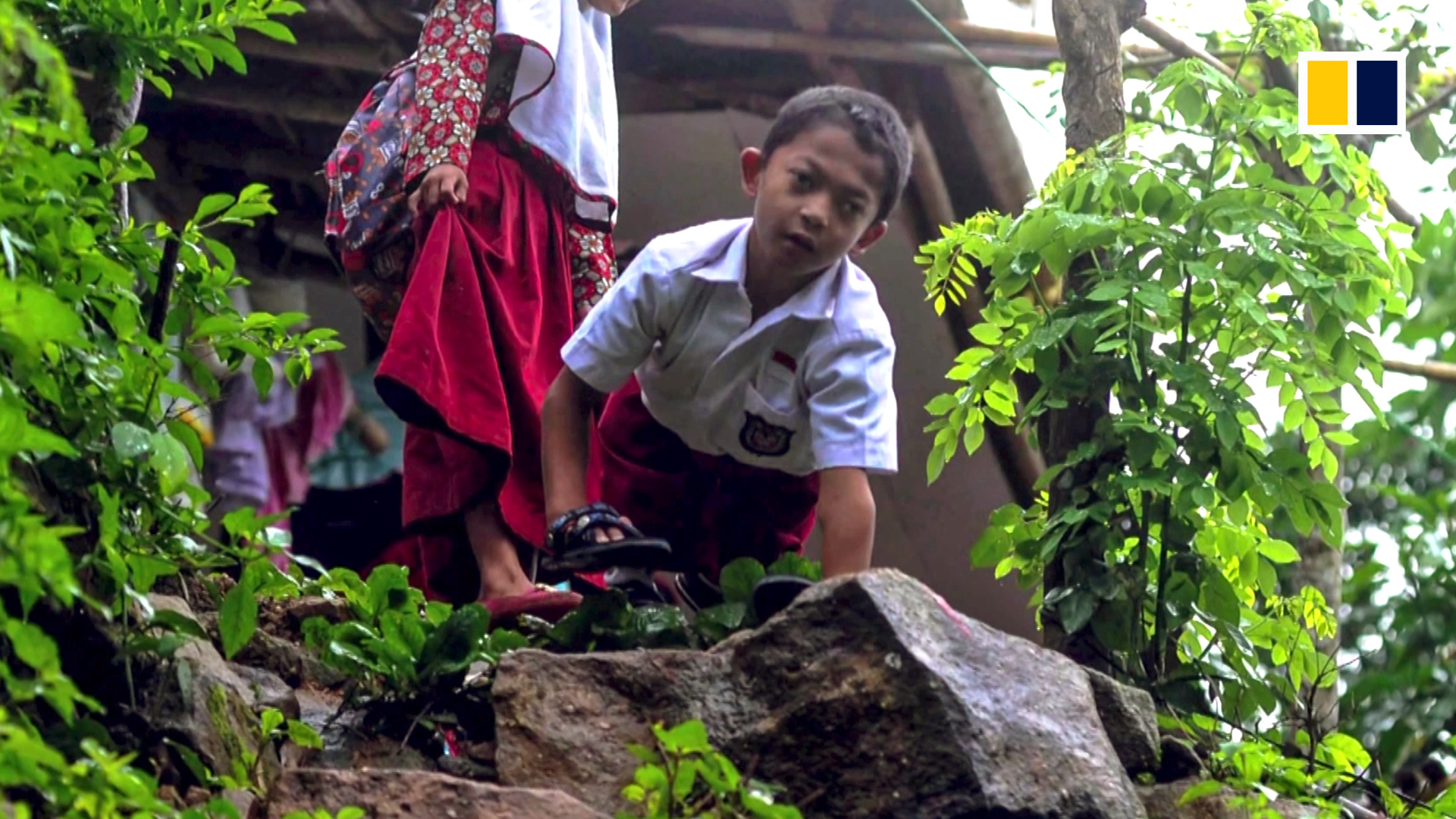 Indonesian eight-year-old boy outpaces disability by walking to school on all fours